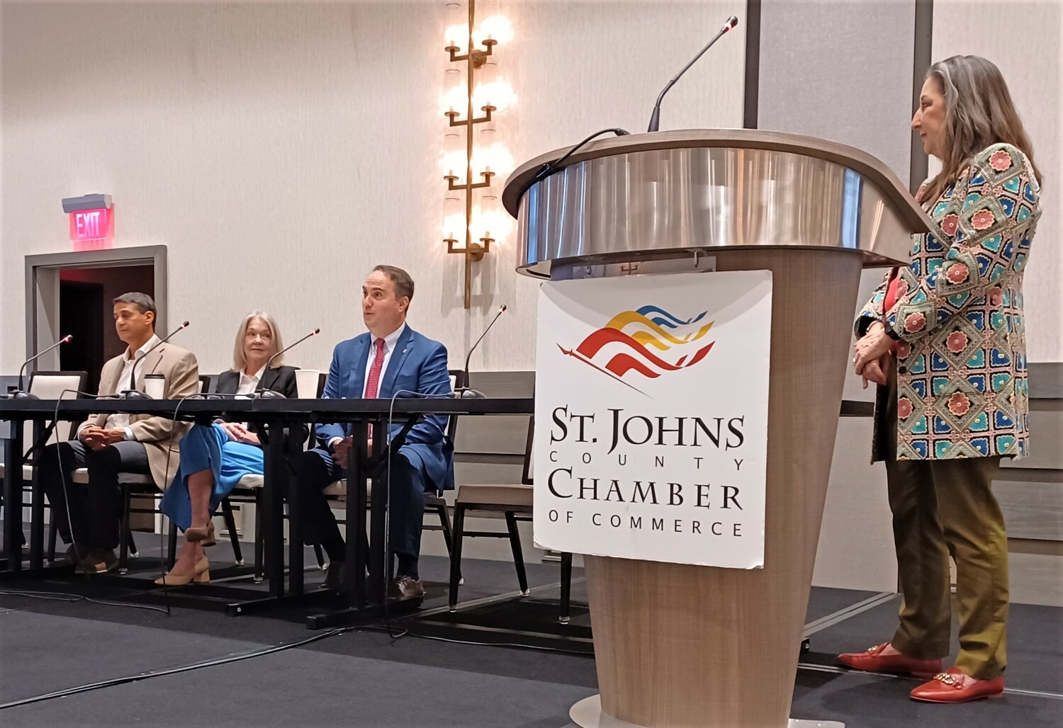 St. Johns County Commissioner Christian Whitehurst speaks during the recent St. Johns County Chamber of Commerce Legislative Breakfast. Seated next to him are St. Augustine Mayor Nancy Sikes-Kline and St. Augustine Beach Mayor Don Samora.