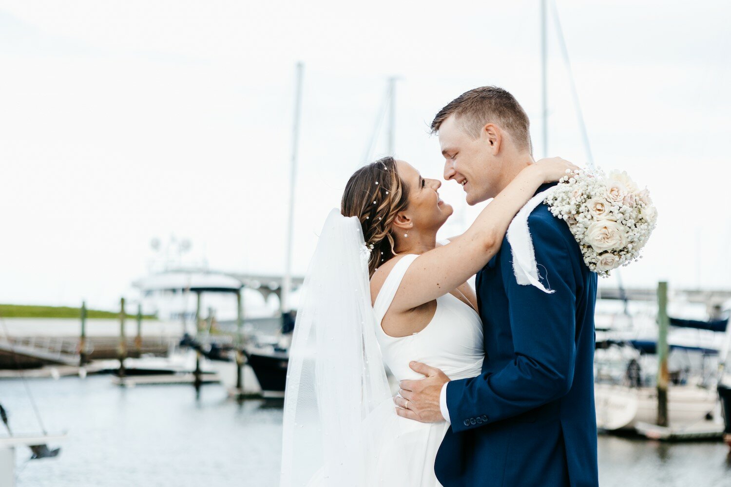 A married couple embraces during their wedding ceremony aboard one of St. Augustine Sailing’s boats.