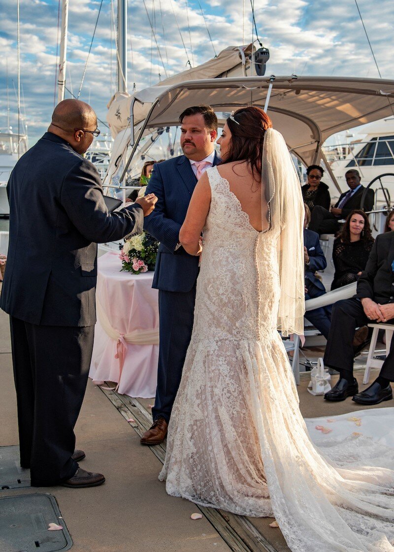 A bride and groom exchange vows aboard one of St. Augustine Sailing’s boats.
